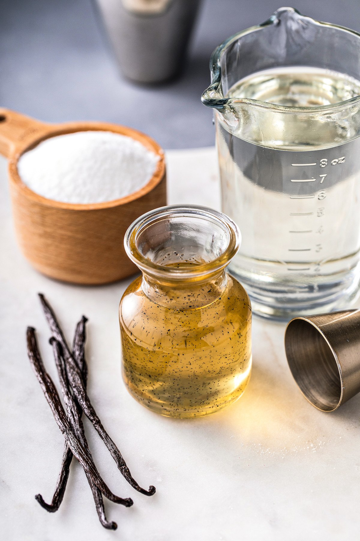 Vanilla syrup and ingredients arranged on a work surface.