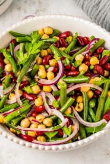 Cold salad made with green beans, kidney beans, and garbanzo beans.