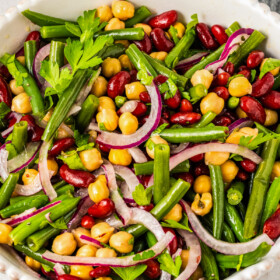 Cold salad made with green beans, kidney beans, and garbanzo beans.