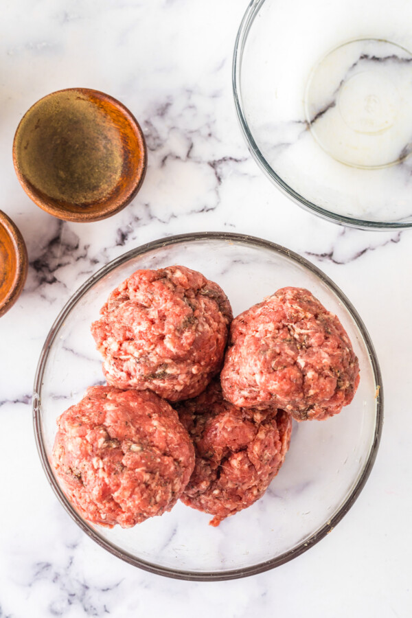 Cheese-stuffed hamburger patties, uncooked.