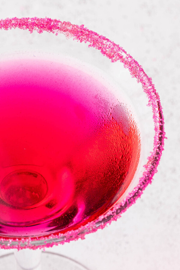 Pink sugar rim on a martini glass.