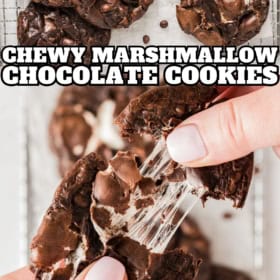 Chewy chocolate marshmallow cookies are being pulled apart to reveal a gooey marshmallow center.