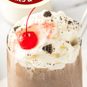 A Cookies & Cream Milkshake with whipped cream and cherry on top.