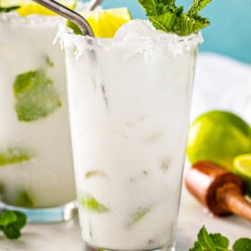 Coconut mojito with fresh mint and a lime wedge.
