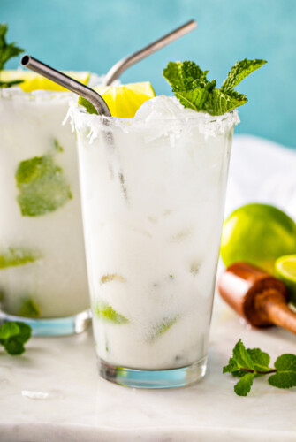 Coconut mojito with fresh mint and a lime wedge.