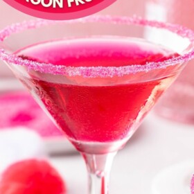 Dragon fruit martini in a martini glass with a pink sugar rim.