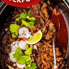 Birria beef shredded in a crockpot with a serving spoon.