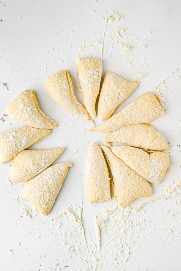 A rough circle of dough, cut into twelve triangles.