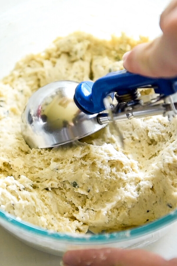Dumpling dough being scooped with a cookie scoop.