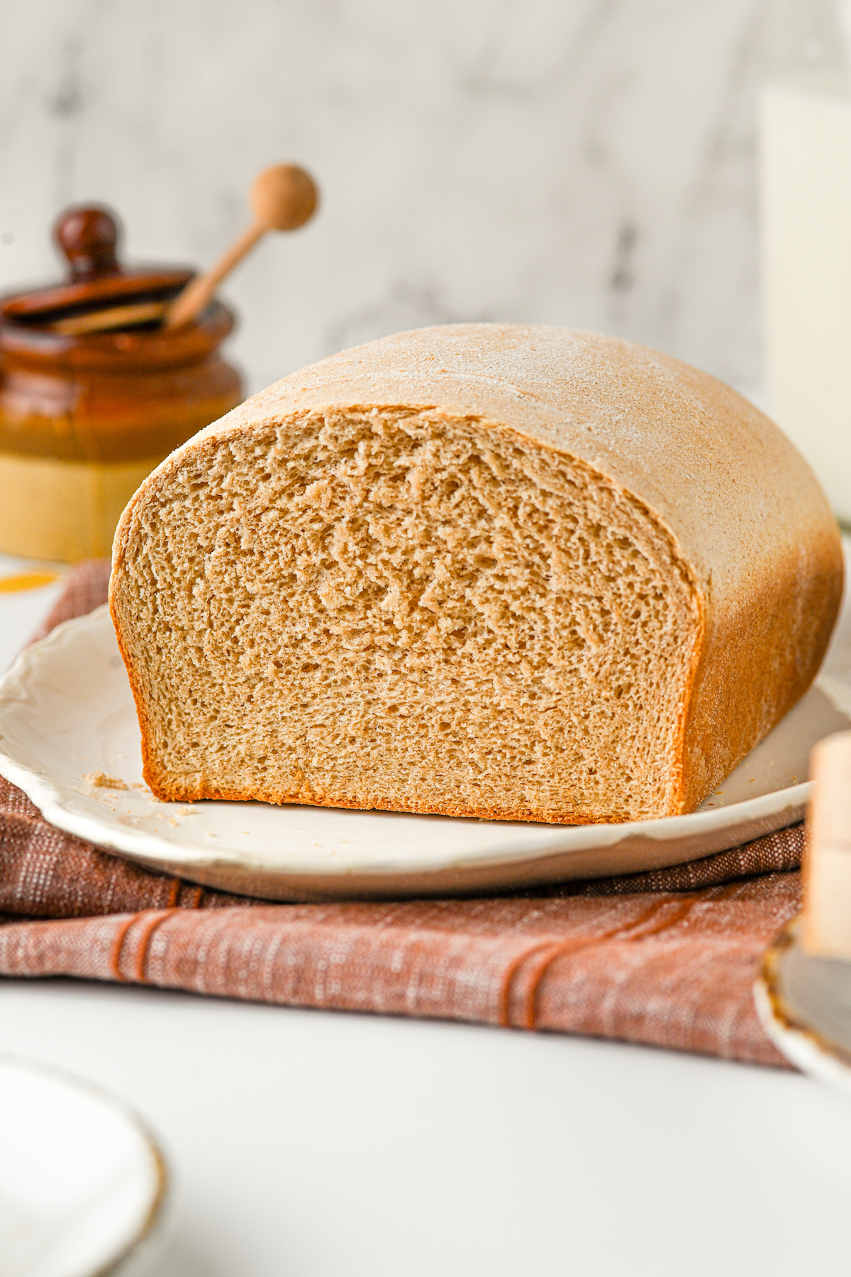 Side view of a cut loaf of bread, showing the texture of the interior.