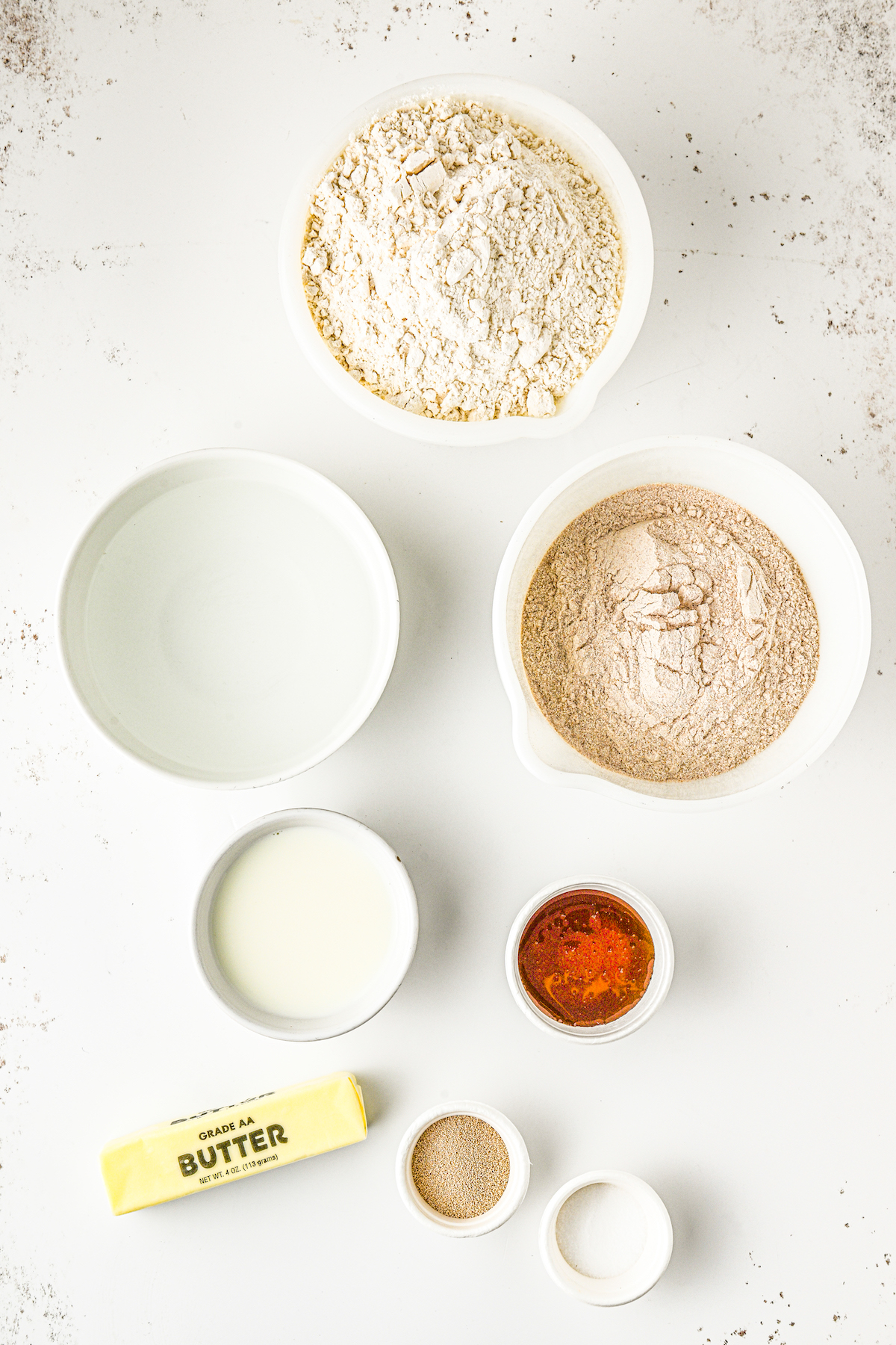 Ingredients for bread, measured and arranged on a table.