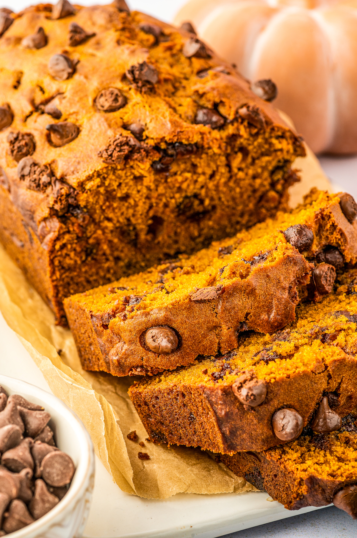 A sliced pumpkin loaf with chocolate chips.