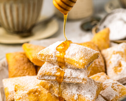 Drizzling sopapillas with honey.