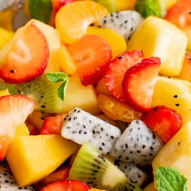 A bowl of fresh Tropical Fruit Salad with honey lime dressing.