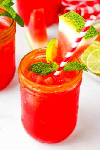 Watermelon agua fresca with ice, mint, and a lime wedge.