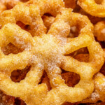 Landscape shot of fried, cinnamon-sugar coated bunuelos.