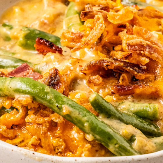 Cheesy green bean casserole topped with french fried onions.