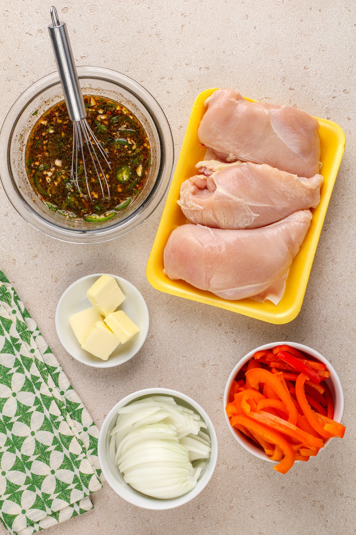 Ingredients for homemade chicken fajitas, arranged on a work surface with a cloth napkin.