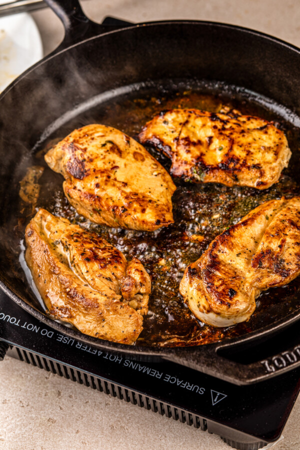 Cooking chicken in a skillet.