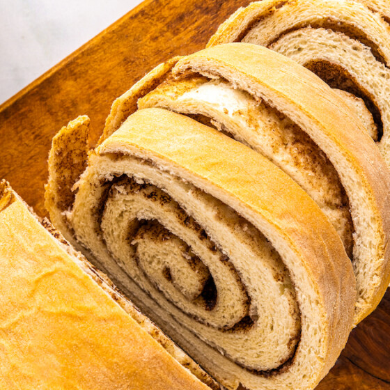 Overhead, landscape shot of cinnamon swirl bread on a cutting board.