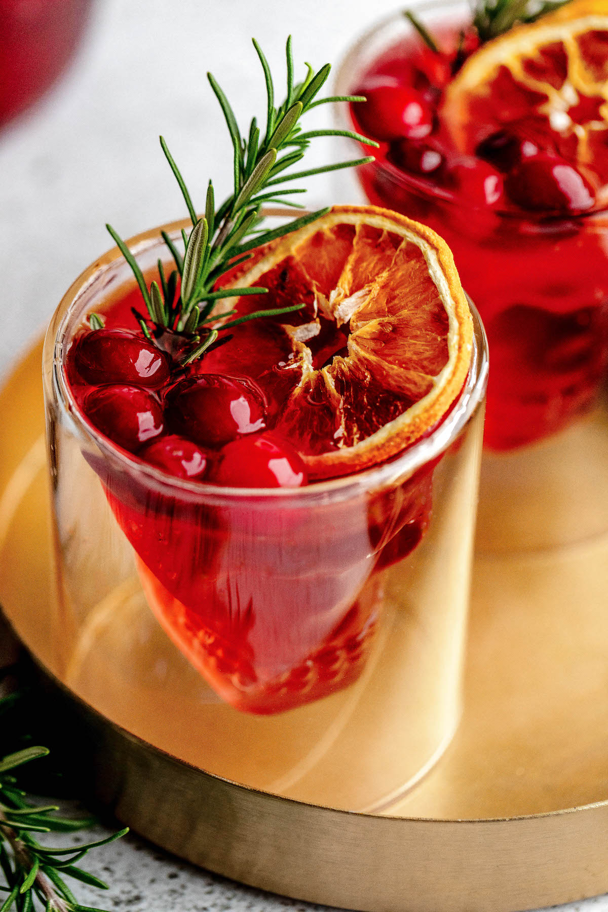 Halloween punch garnished with rosemary and dehydrated orange slices.