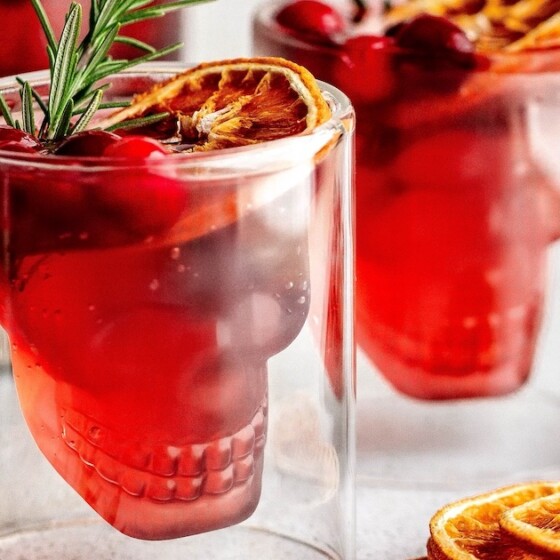 Halloween punch garnished with rosemary and orange.