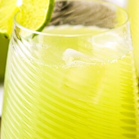 Cucumber Agua Fresca in a glass with a lime garnish.