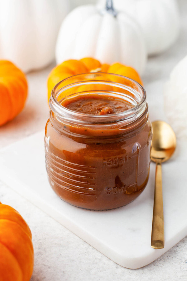 A jar of homemade pumpkin spread with spices.