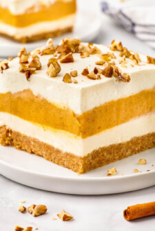 Layered pumpkin dessert topped with chopped nuts.