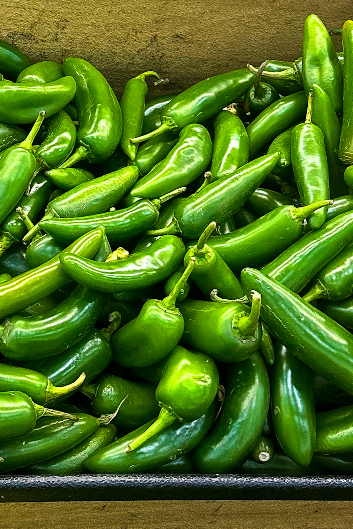 Serrano chiles stacked on top of each other.