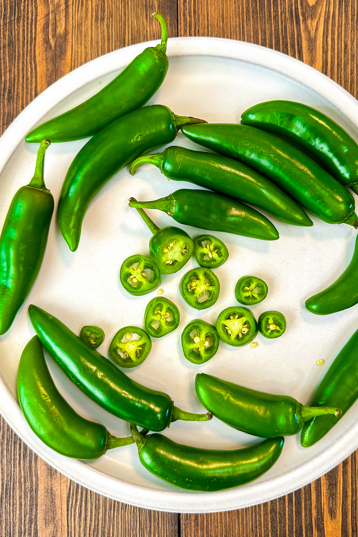 Serrano peppers on a plate sliced into pieces.