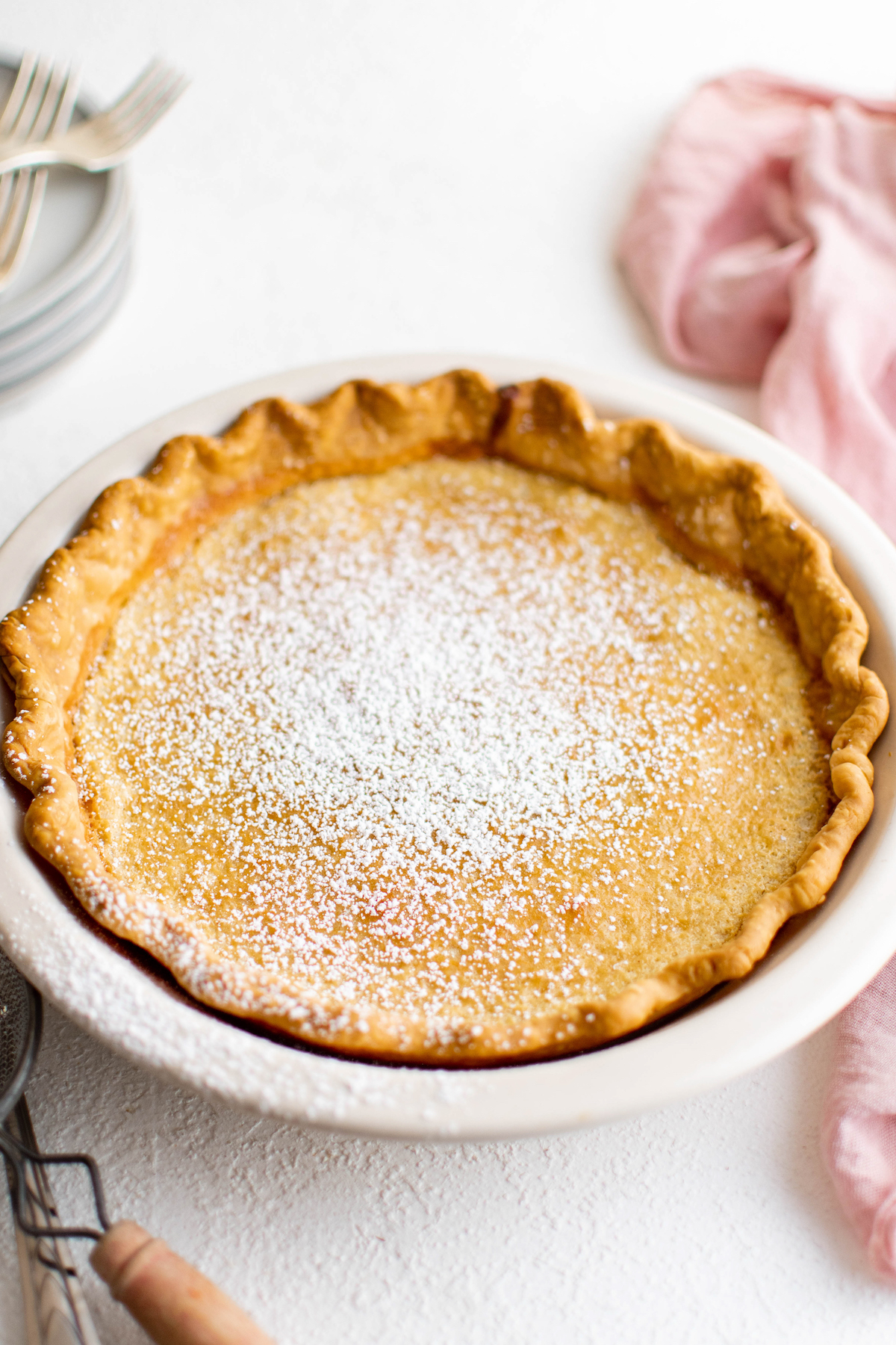 A homemade pie dusted with powdered sugar.