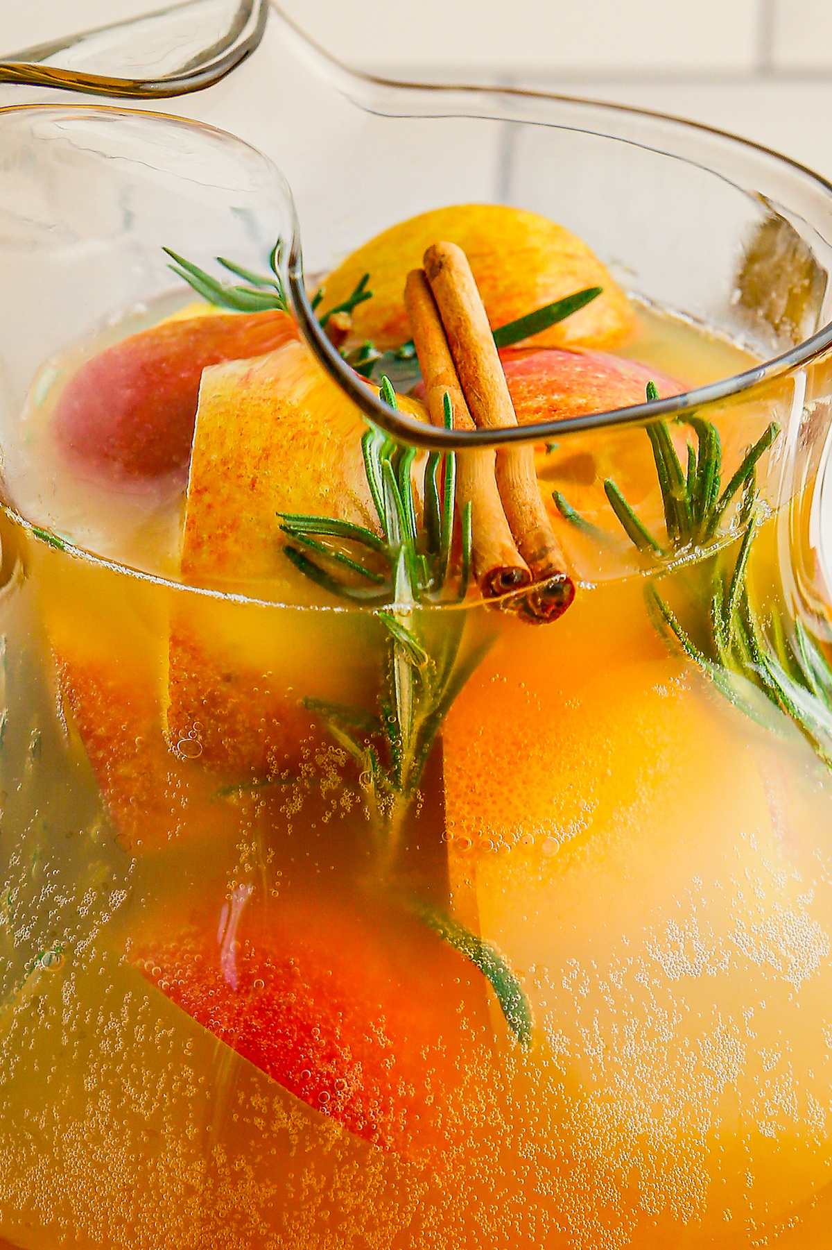 Close-up shot of apple cider punch with ice and garnishes.