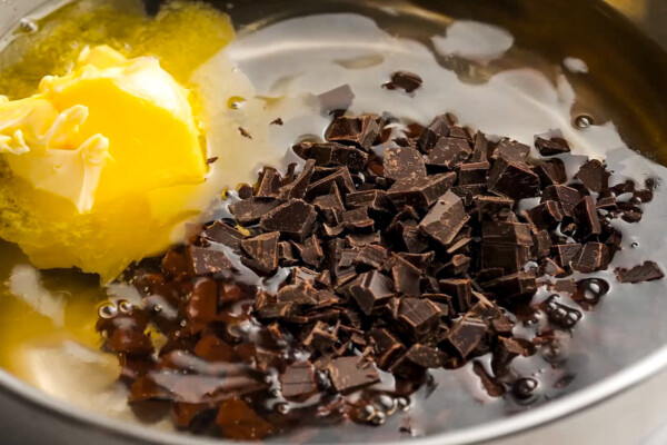 Melting butter, chopped dark chocolate, and other ingredients in a mixing bowl.