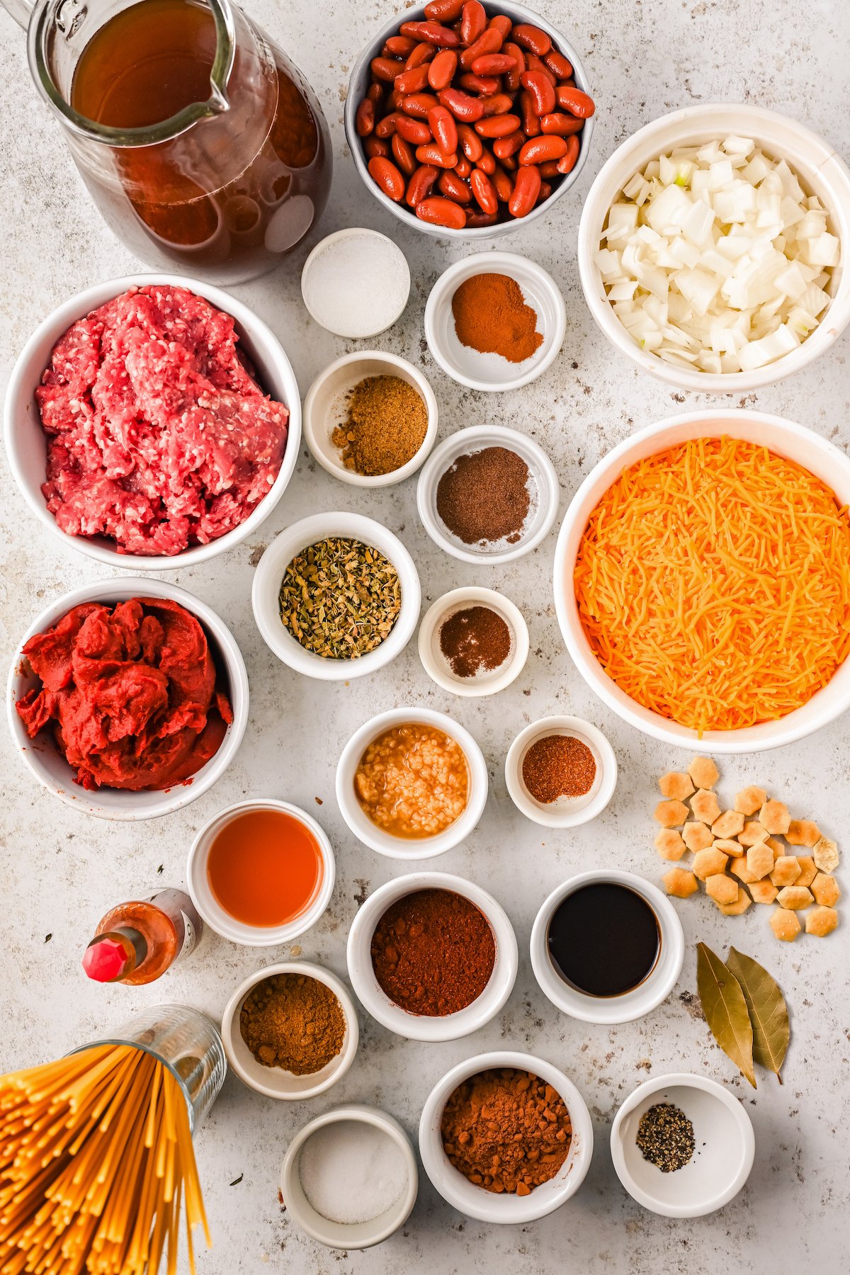 Ingredients for homemade cincinnati chili, arranged on a work surface.