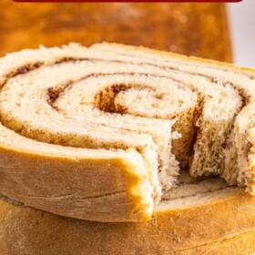 Slices of cinnamon swirl bread stacked on a plate.