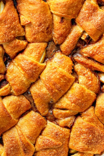 Crescent roll apple dumplings baked in a sweet cinnamon apple cider sauce.