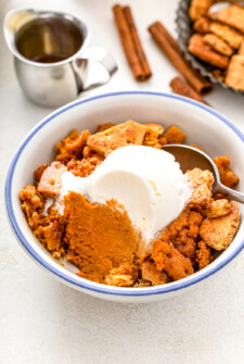 A spoon resting in a dish of pumpkin crumble.