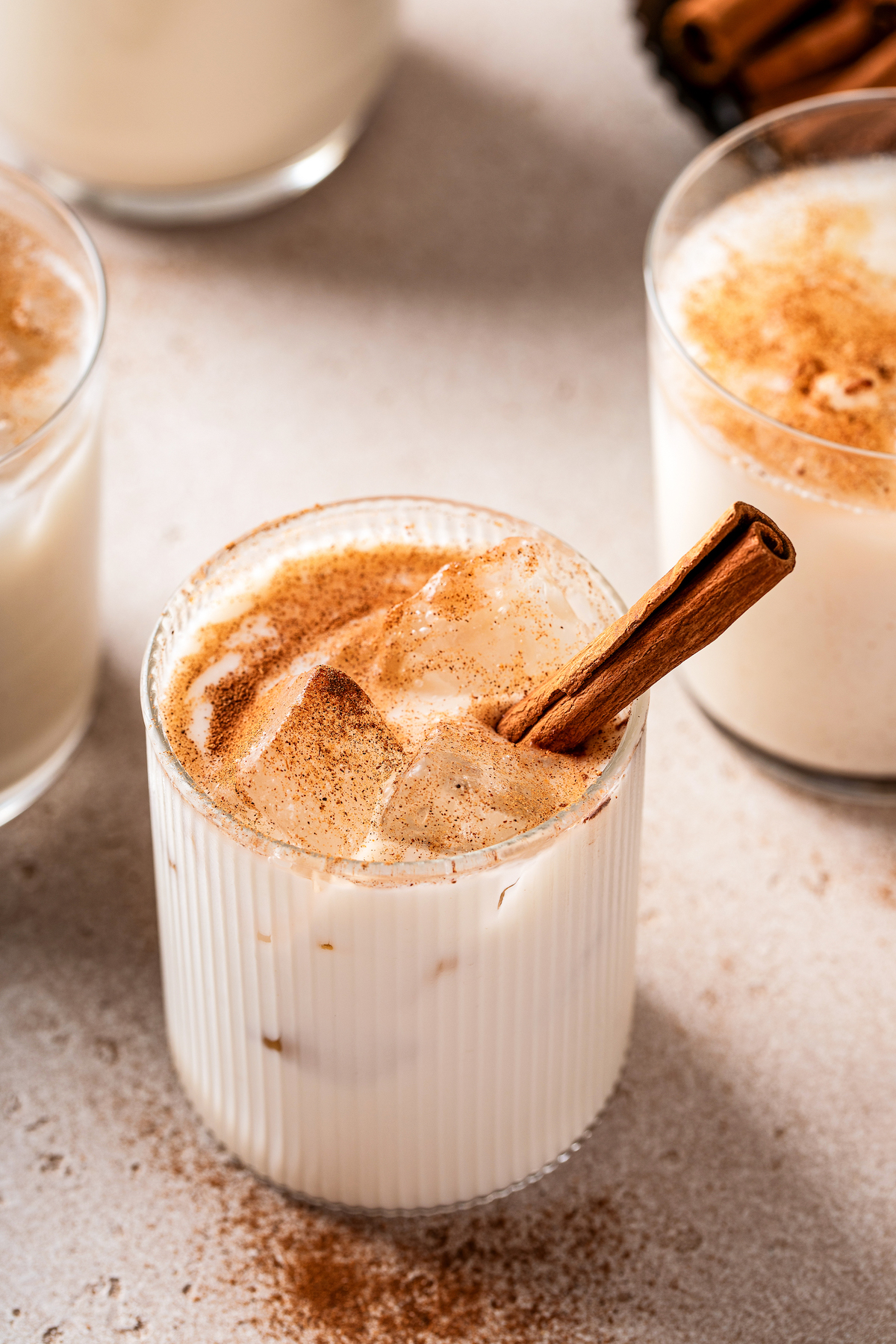 Cinnamon-dusted glasses of homemade Mexican rice drink.
