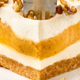 A slice of Pumpkin Delight with a fork stuck in it to take a bite.