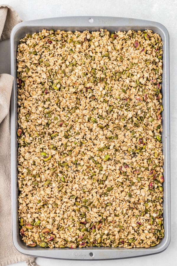 A sheet pan of homemade granola, ready to bake.
