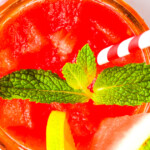 Watermelon Agua Fresca in a glass with a chamoy rim and fresh mint garnish.