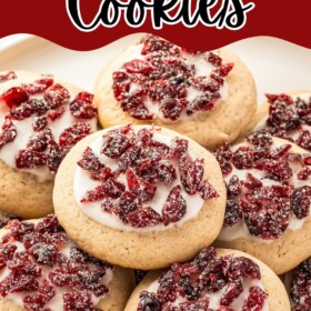 Cranberry cookies stacked on top of each other on a plate.