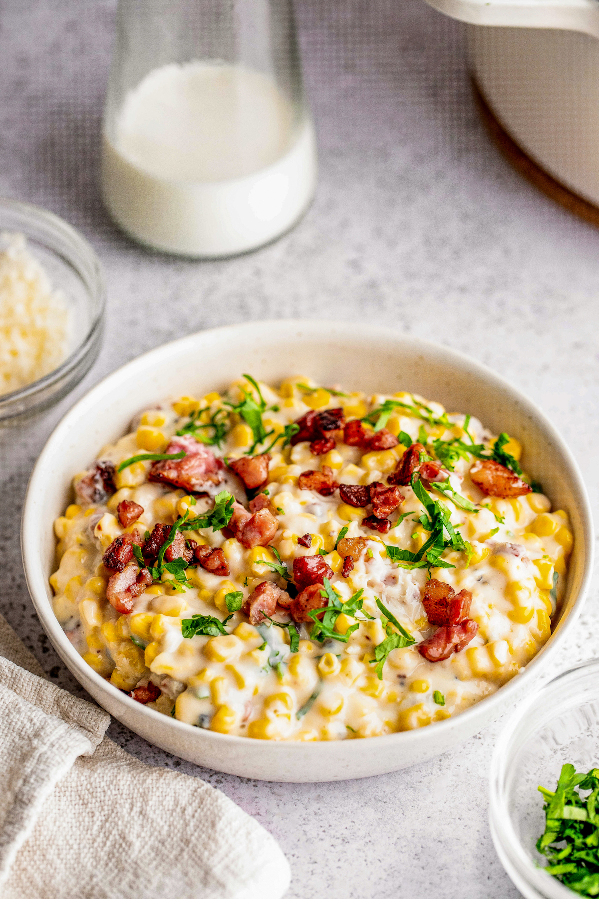 Bowl of creamed corn with crispy bacon on top. 