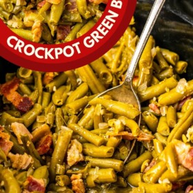 Crock pot green beans with bacon in a slow cooker with a serving spoon.