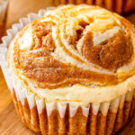 Pumpkin cream cheese muffin swirled with cream cheese on top.