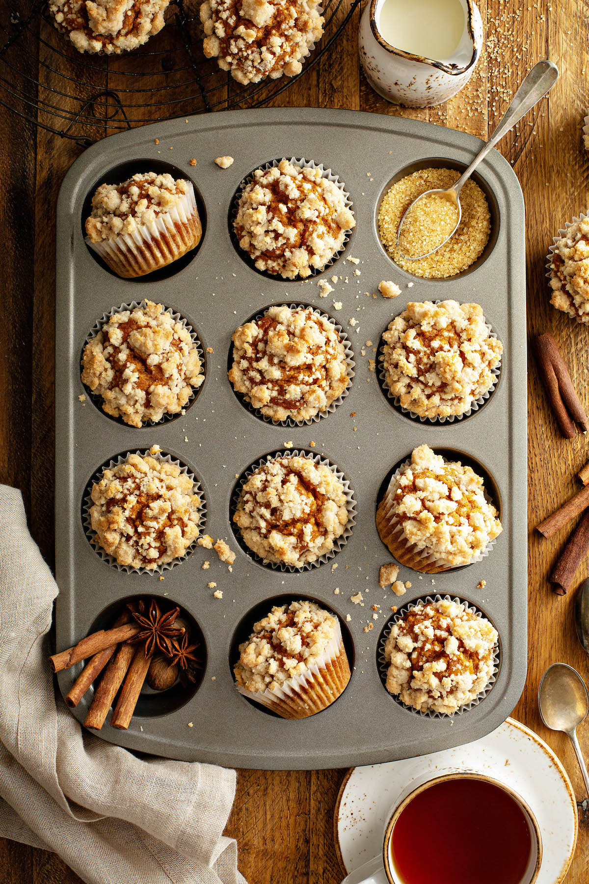 Overhead view of pumpkin streusel muffins in a muffin tin.