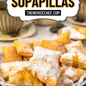 Fried sopapillas sprinkled with powdered sugar and honey.