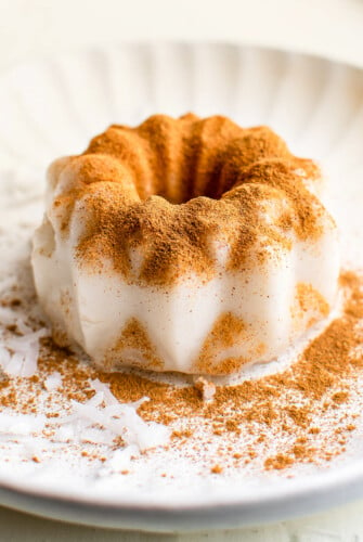 Tembleque on a plate with ground cinnamon sprinkled on top.