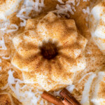 Tembleque on a plate with ground cinnamon sprinkled over the top.